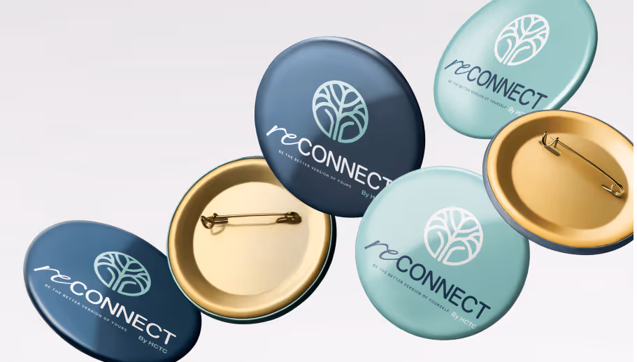 Collection of round pins with a tree logo and the word 'reCONNECT' in blue and teal colors, some showing the pin backs.