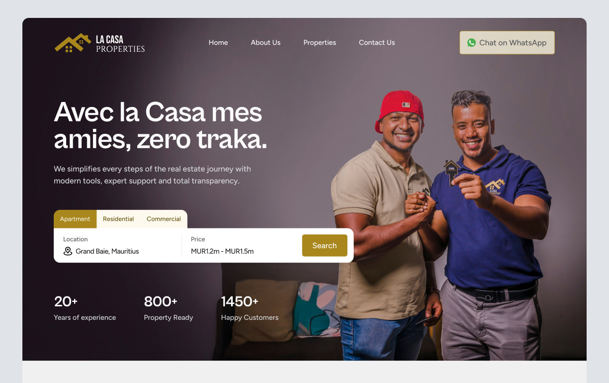 La Casa Properties website hero showing two team members shaking hands and holding a house key beside the property search interface.